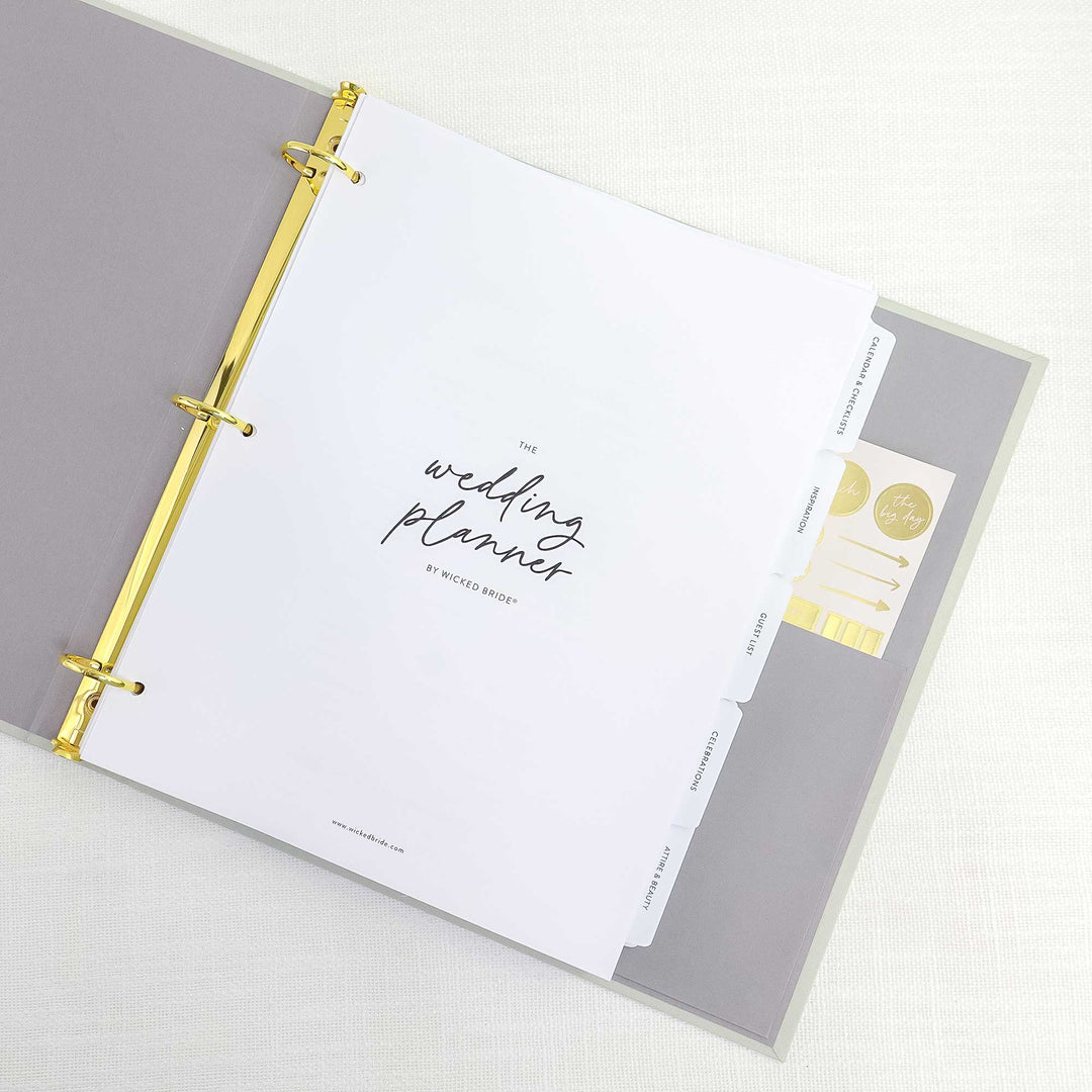 Our custom linen wedding planning binders include our 140+ page wedding planner, 10 tabbed planning sections, a gold foil planner sticker sheet, one inside pocket and gold hardware