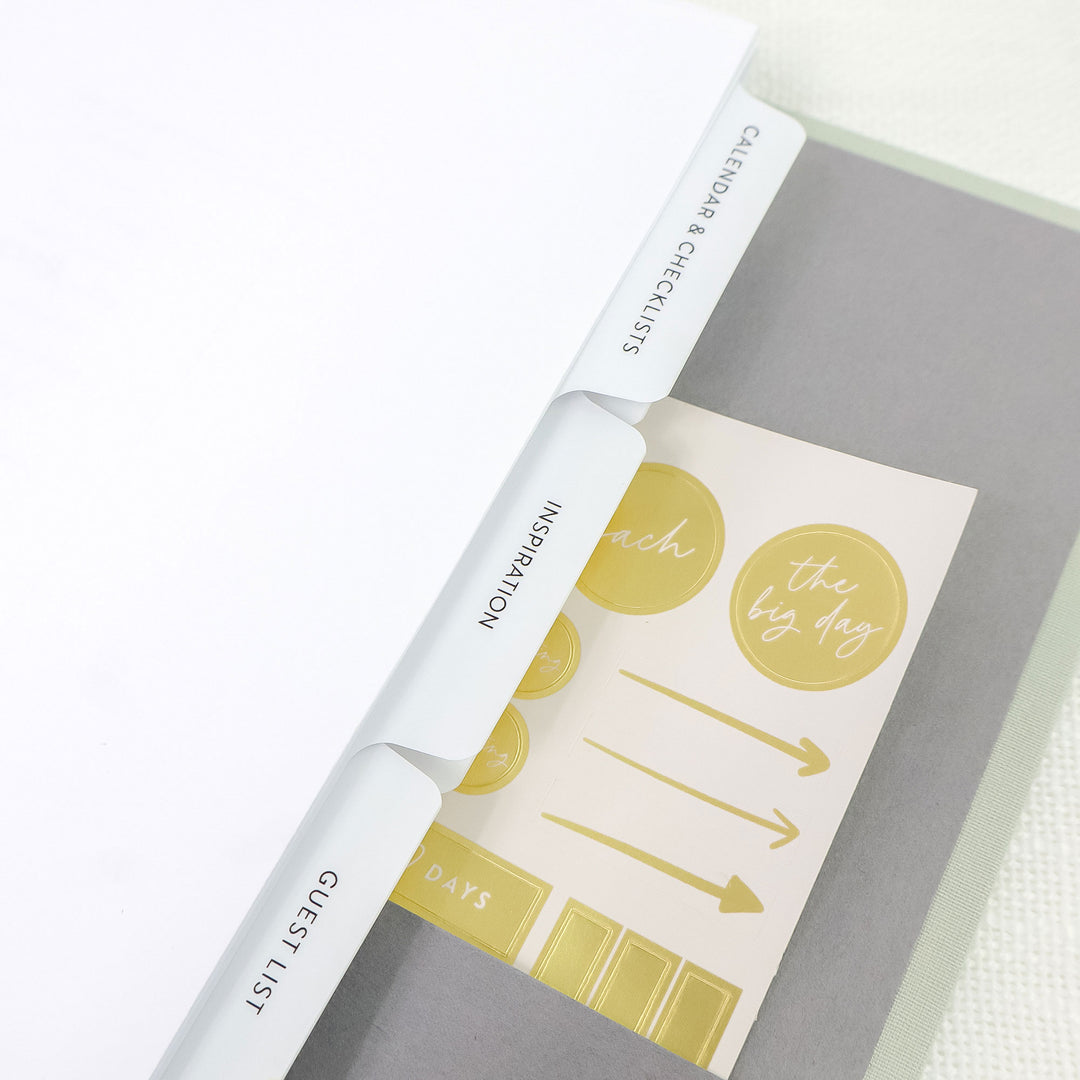 Our custom linen wedding planning binders include our signature planner, ten tabbed planning sections and a gold foil planner sticker sheet