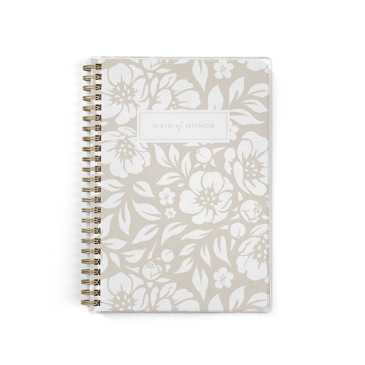 Our exclusive maid of honor planners are the perfect gift for your best friend, shown in a neutral beige floral design.