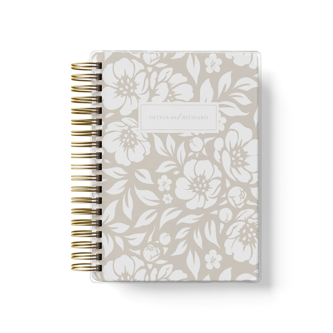 Our soft cover wedding planners are  the best option for brides on a budget, shown in a neutral beige floral design.