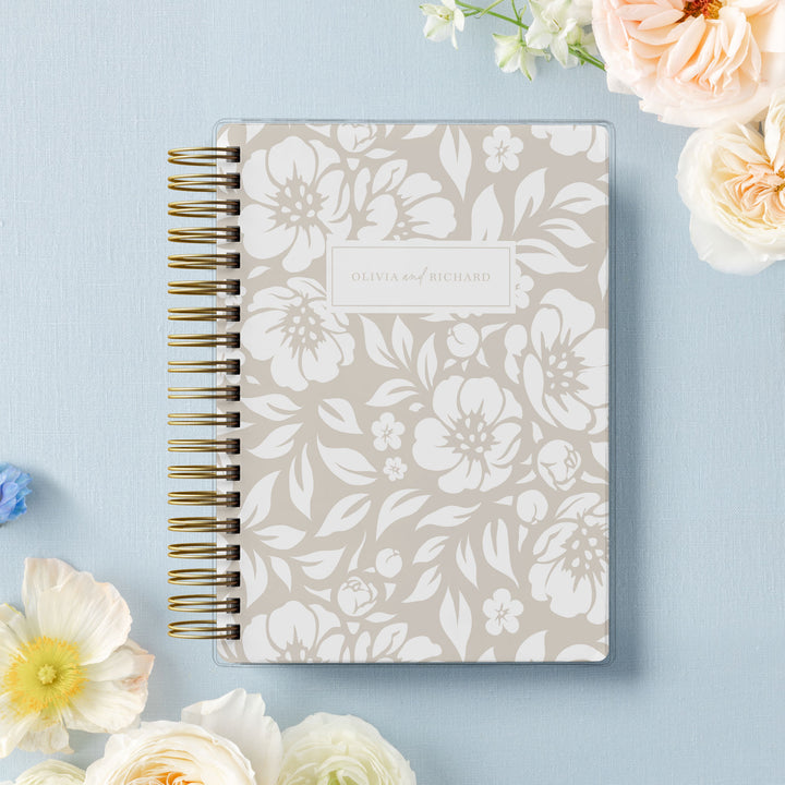 Our soft cover wedding planners are  the best option for brides on a budget, shown in a neutral beige floral design.