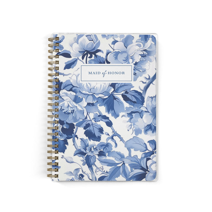 Our exclusive maid of honor planners are the perfect gift for your best friend, shown in a blue toile cabbage rose print