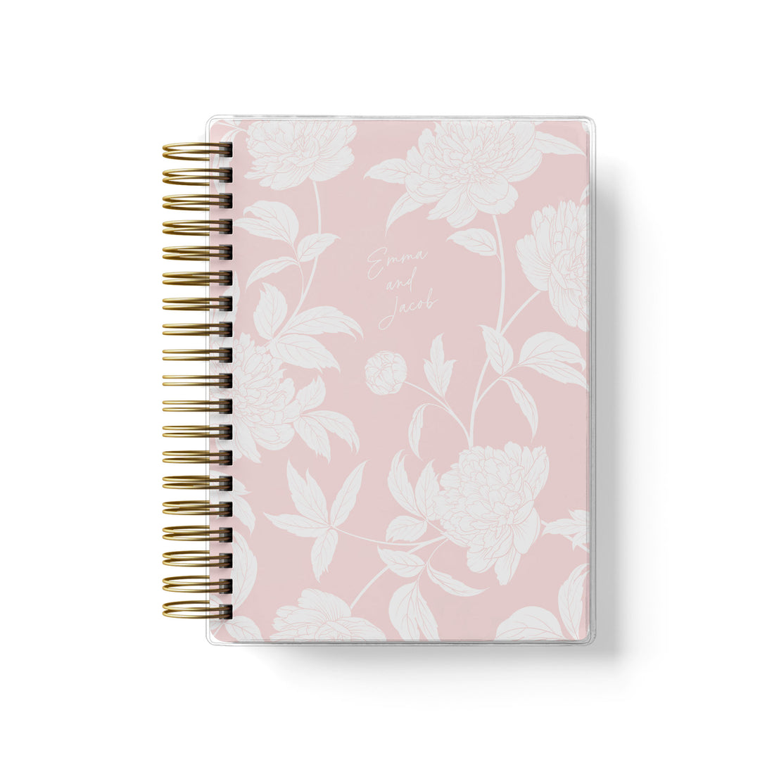 Our soft cover wedding planners are  the best option for brides on a budget, shown in a delicate blush peony floral design.