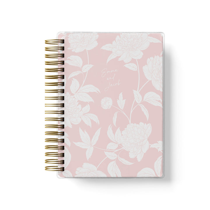 Our soft cover wedding planners are  the best option for brides on a budget, shown in a delicate blush peony floral design.