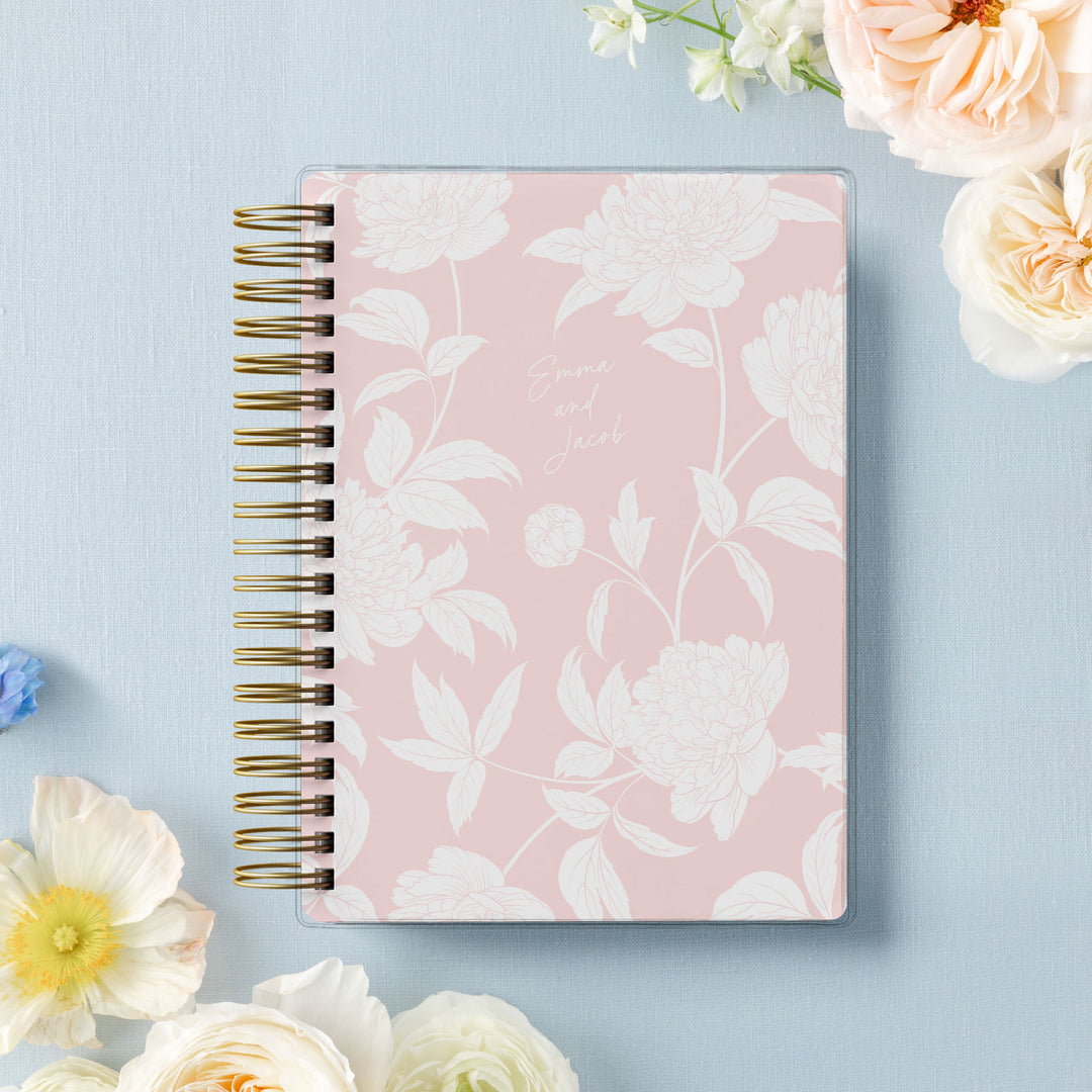 Our soft cover wedding planners are  the best option for brides on a budget, shown in a delicate blush peony floral design.