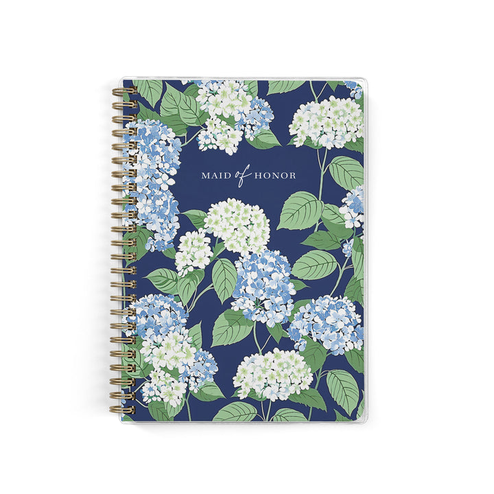 Our exclusive maid of honor planners are the perfect gift for your best friend, shown in a blue, white and green hydrangea pattern