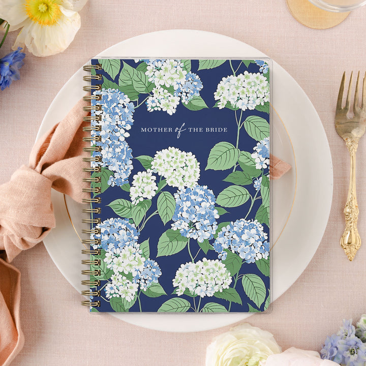 Shown in a blue, white and green hydrangea print, Mother of the Bride planners are exclusive to Wicked Bride.