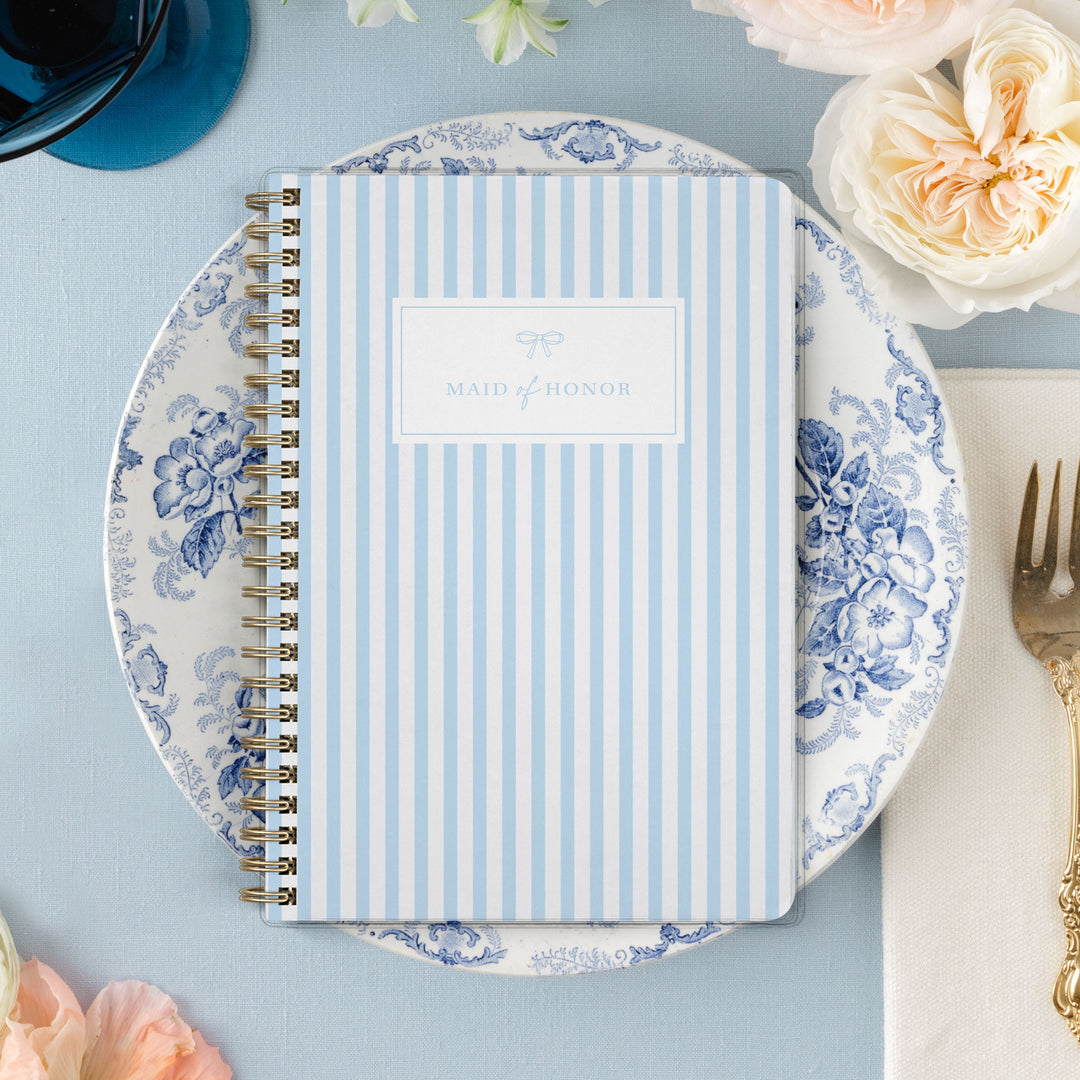 Our exclusive maid of honor planners are the perfect gift for your best friend, shown in a classic stripe design with bow