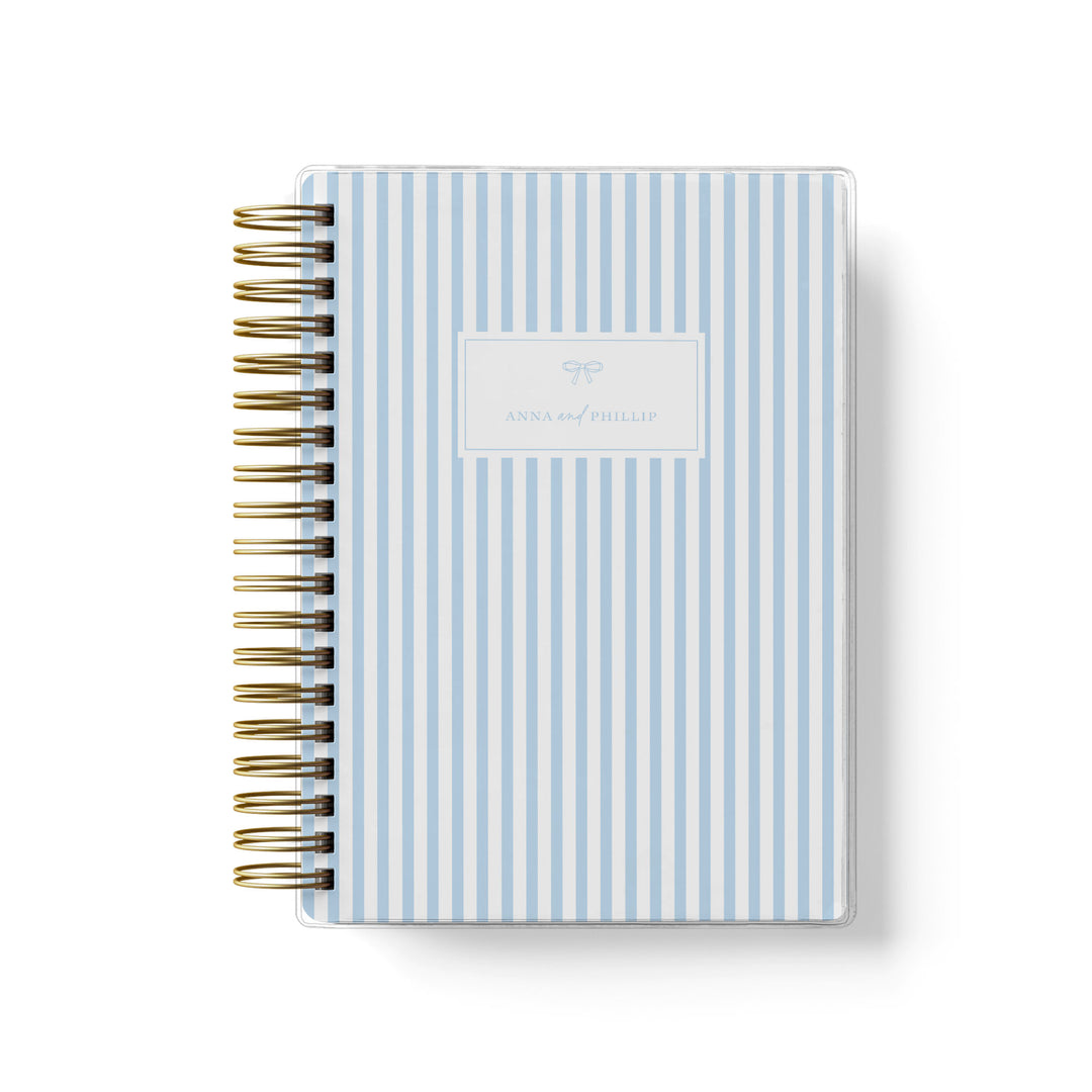 Our soft cover wedding planners are  the best option for brides on a budget, shown in a classic stripe design with bow.