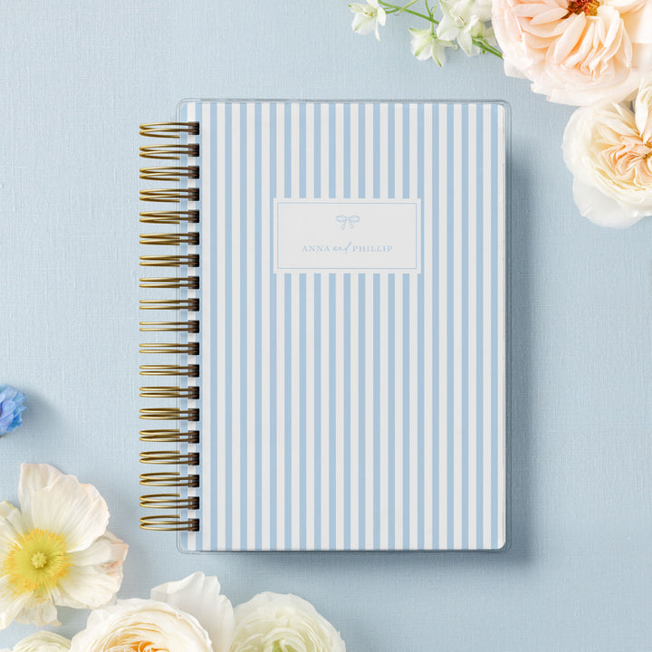 Our soft cover wedding planners are  the best option for brides on a budget, shown in a classic stripe design with bow.