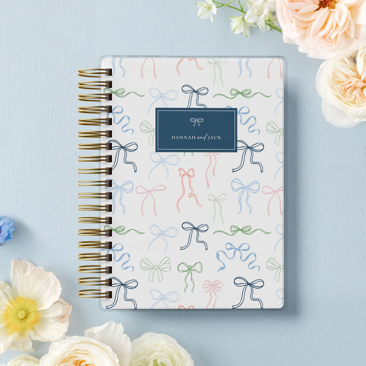 Our soft cover wedding planners are  the best option for brides on a budget, shown in a delicate bow design.