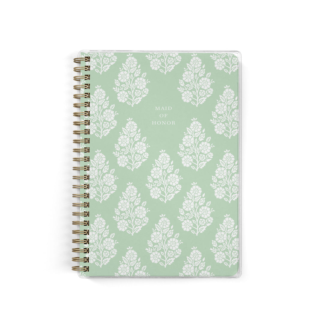 Our exclusive maid of honor planners are the perfect gift for your best friend, shown in a fresh green floral block print