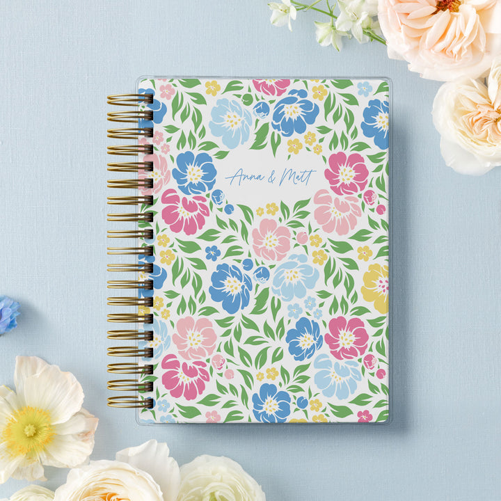 Our soft cover wedding planners are  the best option for brides on a budget, shown in colorful garden floral design.