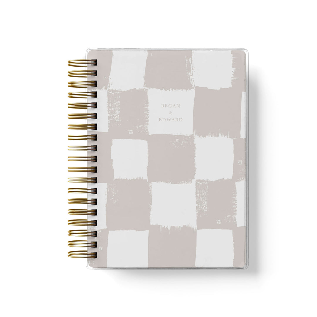 Our soft cover wedding planners are  the best option for brides on a budget, shown in a trendy painted checkerboard pattern.