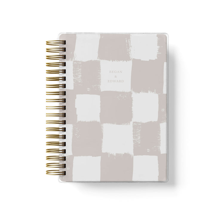 Our soft cover wedding planners are  the best option for brides on a budget, shown in a trendy painted checkerboard pattern.