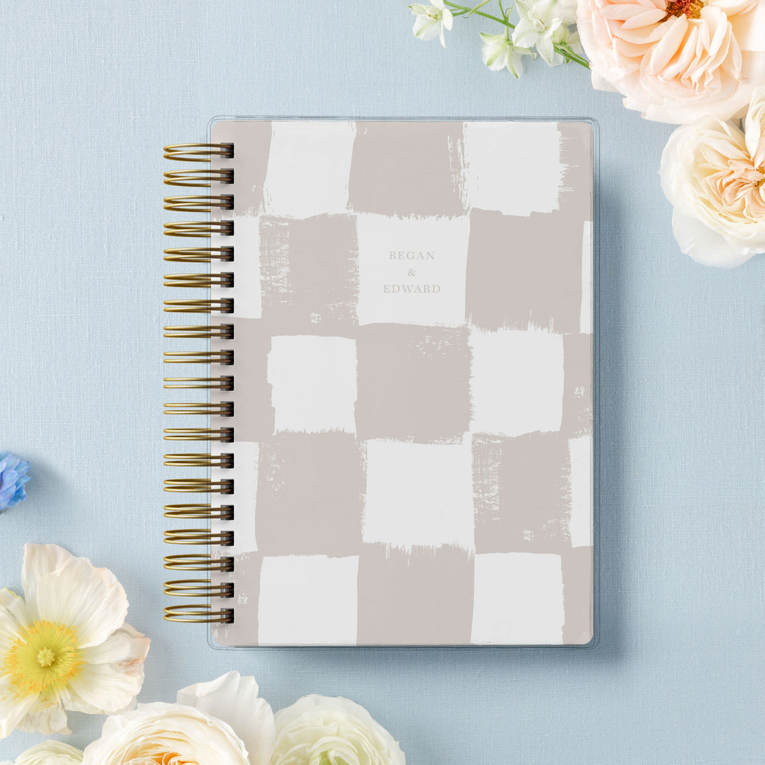 Our soft cover wedding planners are  the best option for brides on a budget, shown in a trendy painted checkerboard pattern.