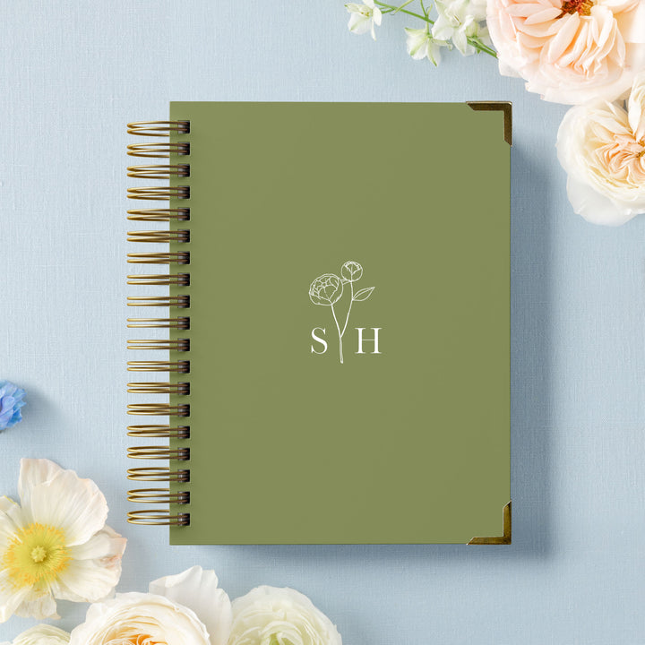 Our LGBT wedding planner books are all-inclusive and gender-neutral, shown in a delicate peony monogram design