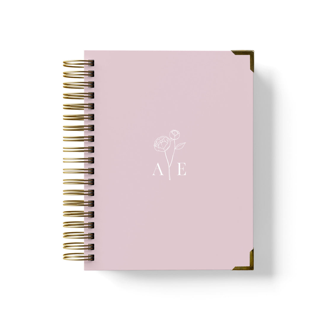 Our luxury wedding planner books are the best a bride can buy, featuring a delicate peony stem with monogram