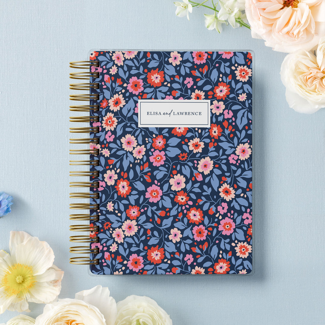 Our soft cover wedding planners are  the best option for brides on a budget, shown in colorful preppy floral design of navy, red and pink.