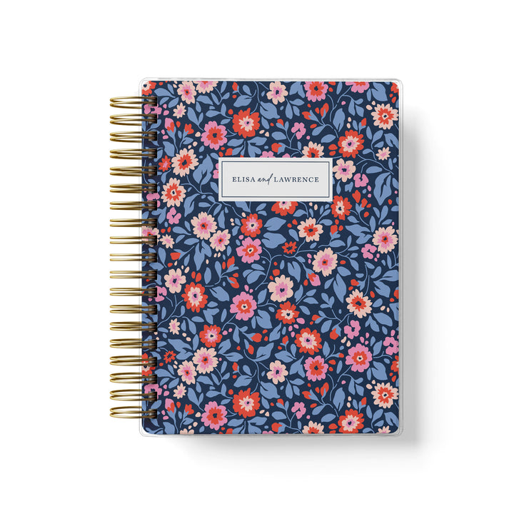 Our soft cover wedding planners are  the best option for brides on a budget, shown in colorful preppy floral design of navy, red and pink.